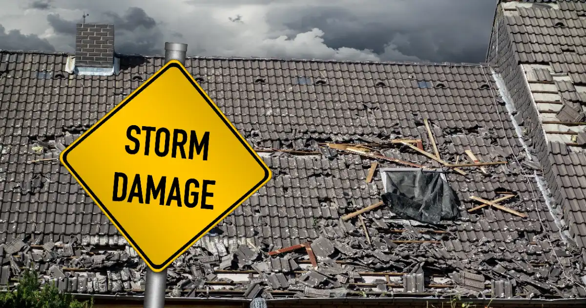 storm damage sign with damaged roof in the background