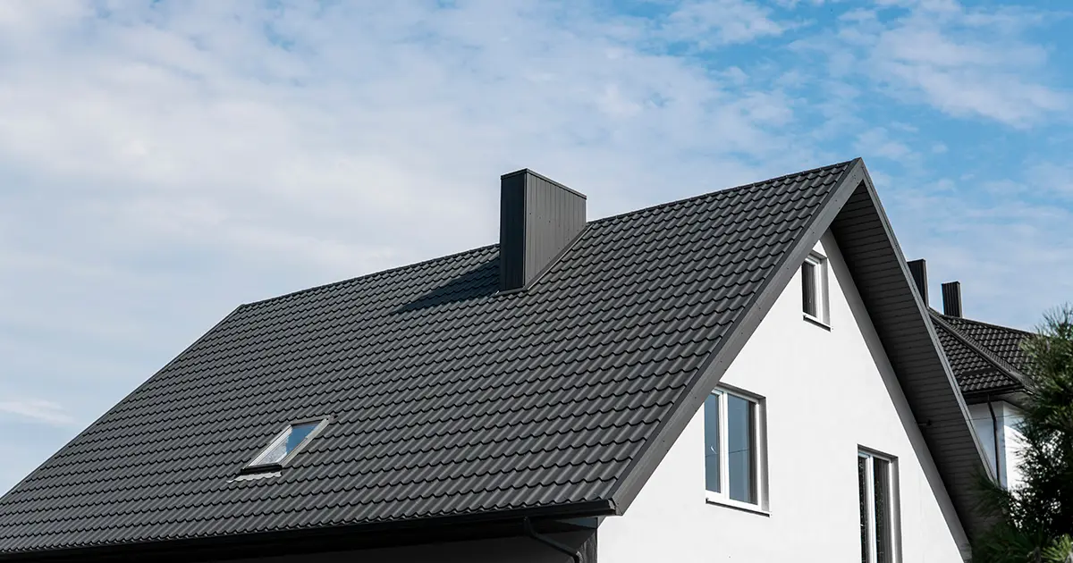 Modern home with black metal tile roof and energy-efficient residential roofing design